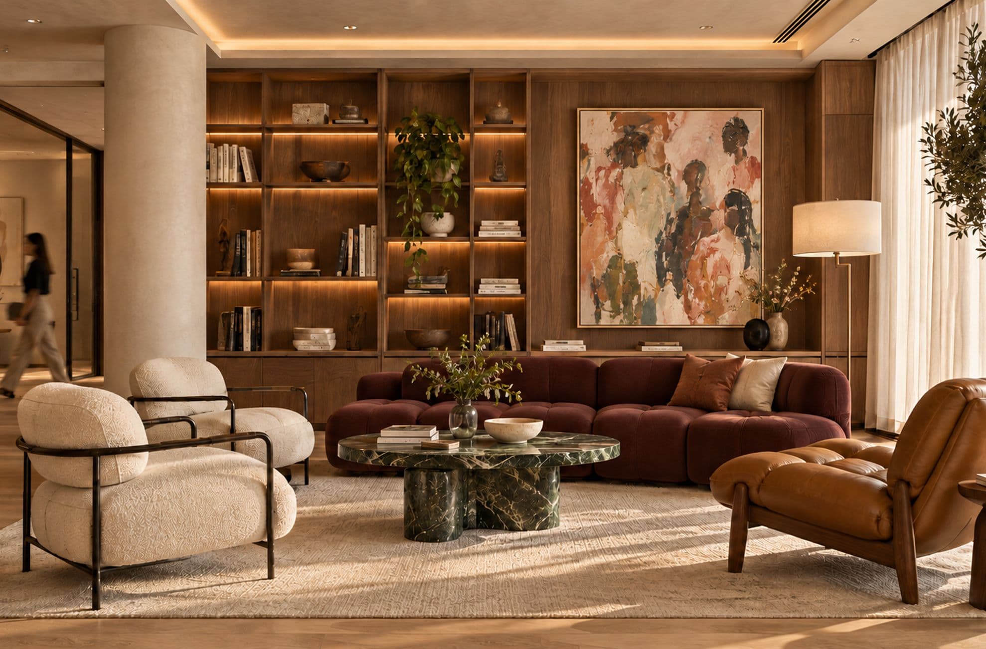 Lounge with walnut library shelving, bouclé armchairs and a large abstract painting